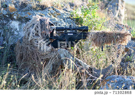 camouflaged sniper rifle with optic sight Stock Photo - Alamy