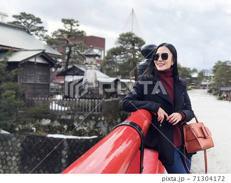 Happy woman tourist enjoy view in Red Nakabashi Bridge of Takayama, Japan 71304172