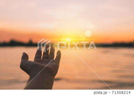 Woman hands reach out to the sky like praying in front of sky. 71308214
