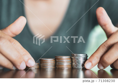 Gold coins on table and green nature bokeh background. Gold coins on table and green nature bokeh background. 71308230