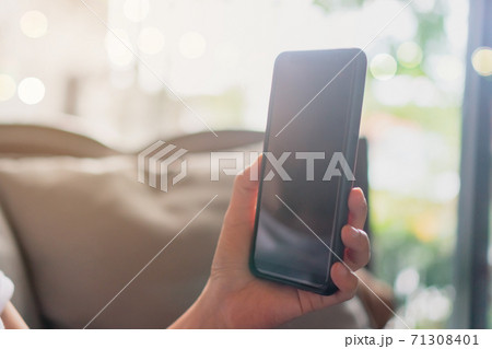 Womanhand using smartphone to do work business, social network, communication in public cafe work space. Womanhand using smartphone to do work business, social network, communication in public cafe work space. 71308401