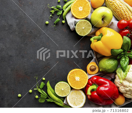 Healthy food. Vegetables and fruits on a black concrete background. Healthy food. Vegetables and fruits on a black concrete background. 71316802