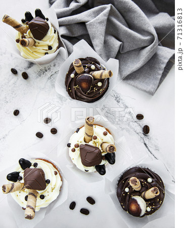 Chocolate cupcakes on white marble background 71316813