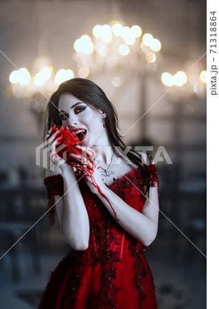 Bloodthirsty female vampire in red dress.の写真素材