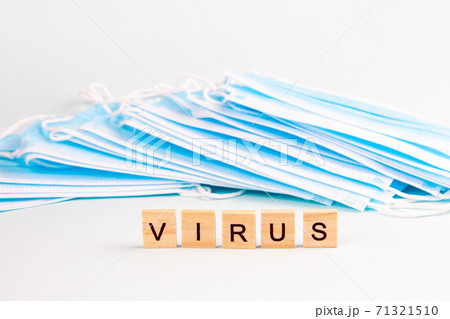 Text "virus" with copy space on the background of protective face masks. Virus and epidemic concept. 71321510
