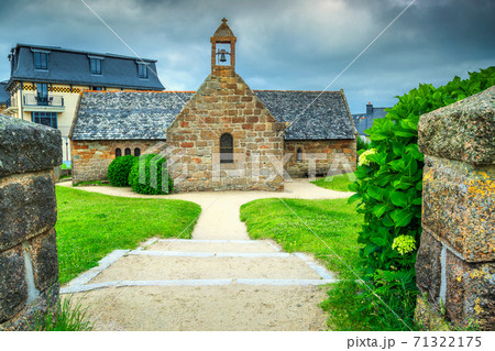 Old stone church with flowered entrance in Brittany region, France Old stone church with flowered entrance in Brittany region, France 71322175