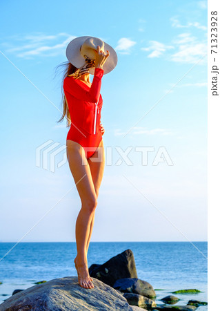 Slender woman in swimsuit at seaside in summer 71323928