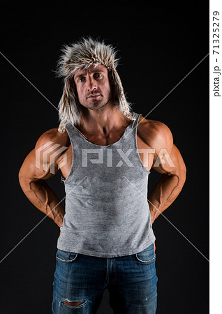 Strong and fit. Bodybuilder wear fur hat in casual style black background. Bodybuilder Strong and fit. Bodybuilder wear fur hat in casual style black background. Bodybuilder 71325279