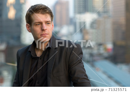 Face of young handsome businessman thinking in the city 71325571