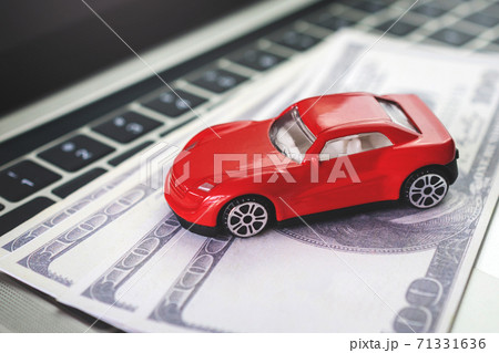 Car model, money and Notebook on wooden desk. shopping online and car payment by using laptop Car model, money and Notebook on wooden desk. shopping online and car payment by using laptop 71331636