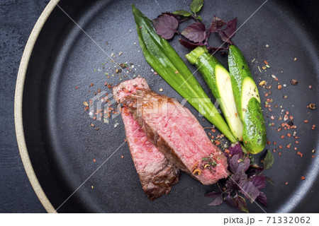 Modern barbecue dry aged sliced fillet steak with wild garlic and baby zucchini Modern barbecue dry aged sliced fillet steak with wild garlic and baby zucchini 71332062