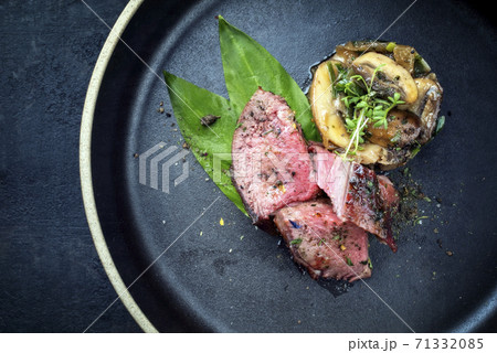 Traditional barbecue dry aged sliced venison filet steak with potato mushroom terrine Traditional barbecue dry aged sliced venison filet steak with potato mushroom terrine 71332085