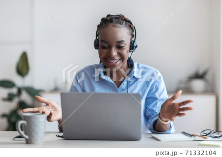 Web Conference. Black Female Employee In Headset Making Video Call With Laptop Web Conference. Black Female Employee In Headset Making Video Call With Laptop 71332104