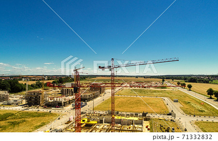 Construction site with cranes and the shells for new houses Construction site with cranes and the shells for new houses 71332832