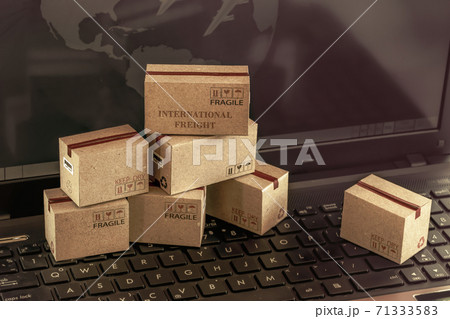 Concept of transportation and online shopping : Packaging cardboard boxes and notebook keyboard. International freight for online shopping, e-commerce that can be done easily using an online internet. 71333583