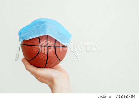 Basketball ball with medical mask. Basketball ball with medical mask. 71333784
