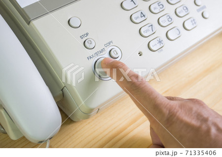 hand man are using a fax machine in the office, equipment for data transmission. 71335406