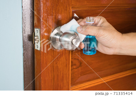 Prevention cleaning Door handles by Disinfectant solution for killing corona virus on touching surfaces, concept coronavirus COVID19 Prevention cleaning Door handles by Disinfectant solution for killing corona virus on touching surfaces, concept coronavirus COVID19 71335414