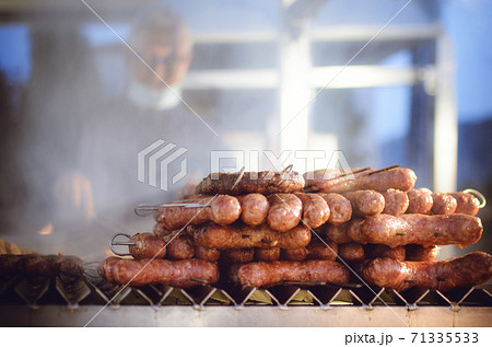 man grilling traditional italian sausages man grilling traditional italian sausages 71335533