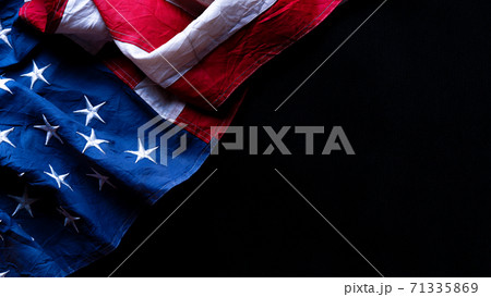US American flag against black background. For Memorial, Presidents, Veterans, Labor, Independence or 4th of July celebration day. Top view, copy space for text. US American flag against black background. For Memorial, Presidents, Veterans, Labor, Independence or 4th of July celebration day. Top view, copy space for text. 71335869