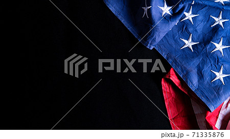 US American flag against black background. For Memorial, Presidents, Veterans, Labor, Independence or 4th of July celebration day. Top view, copy space for text. US American flag against black background. For Memorial, Presidents, Veterans, Labor, Independence or 4th of July celebration day. Top view, copy space for text. 71335876