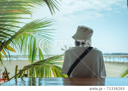 solo asian woman short hair relax at salt field and beach with sky background in summer 71336263