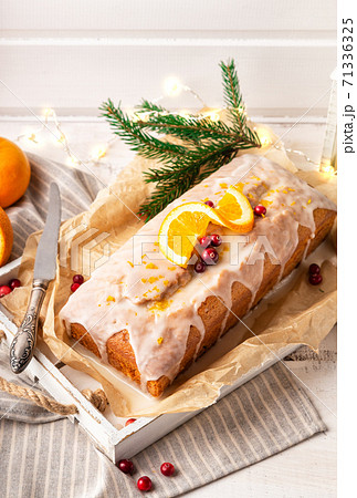 Christmas orange cake with cranberries and sugar icing 71336325