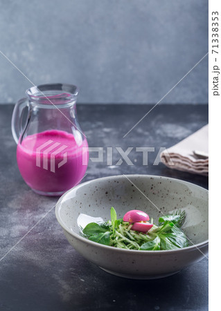 Traditional cold summer beetroot soup with vegetables in a white bowl. Traditional cold summer beetroot soup with vegetables in a white bowl. 71338353