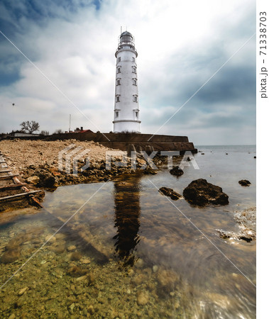 High lighthouse on the seashore 71338703