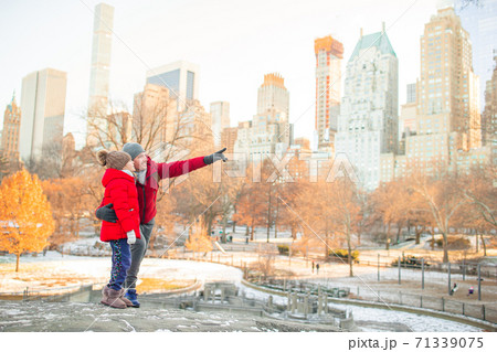 Family of father and kid in Central Park during their vacation in New York City Family of father and kid in Central Park during their vacation in New York City 71339075