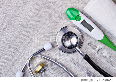 Stethoscope, thermometer, bandage and ampule. 71340621