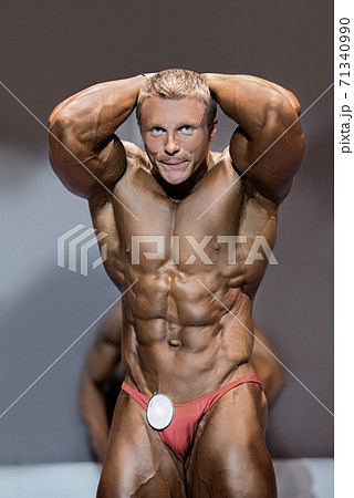 Muscular male flexing abs. 71340990