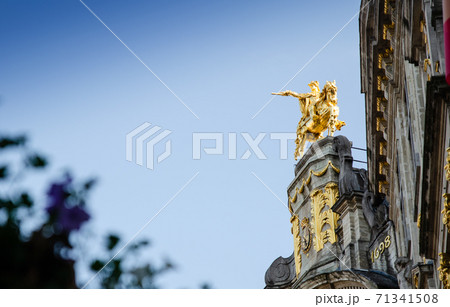 Brussels, Belgium, August 2019. The Great Square or Grote Markt. The evening light enhances its beauty of the magnificent Baroque and Gothic buildings. In evidence the golden equestrian statue 71341508