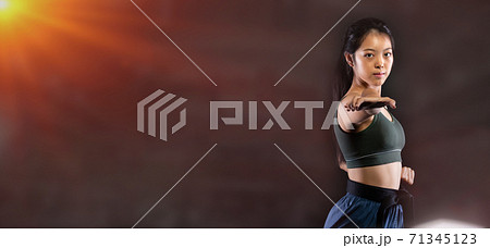 TaeKwonDo Karate teenager athlete kick punch black background isolated 71345123