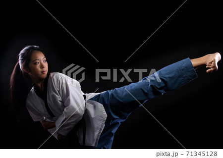 TaeKwonDo Karate teenager athlete kick punch black background isolated TaeKwonDo Karate teenager athlete kick punch black background isolated 71345128
