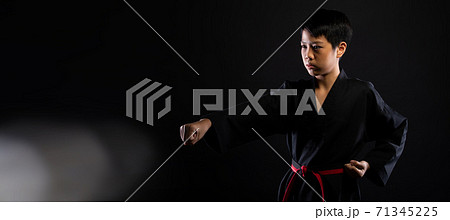 TaeKwonDo Karate teenager athlete kick punch black background isolated TaeKwonDo Karate teenager athlete kick punch black background isolated 71345225