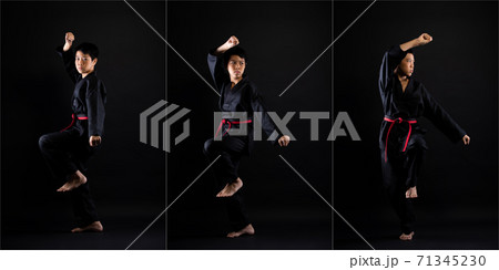 TaeKwonDo Karate teenager athlete kick punch black background isolated 71345230
