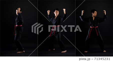TaeKwonDo Karate teenager athlete kick punch black background isolated 71345231