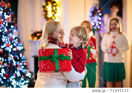 Family on Christmas day. Kids with gifts at door. 71345517