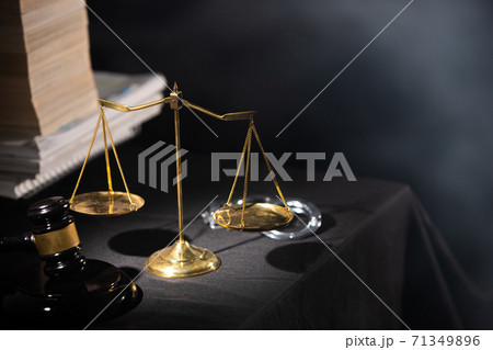 Libra Balance Scale is Symbol of Justice for Judge to put Hammer on Trial. Background Banner copy space with handcuff and Legal Law Textbook Libra Balance Scale is Symbol of Justice for Judge to put Hammer on Trial. Background Banner copy space with handcuff and Legal Law Textbook 71349896