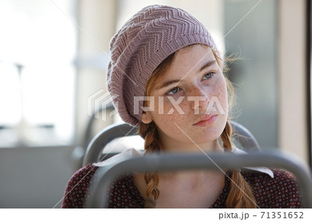Portrait of a freckled teenage girl with pigtails 71351652
