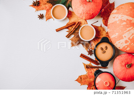 Autumn food. Frame of pumpkin puree soup, leaves. Top view. Autumn harvest, pumpkins, leaves on grey as abstract background. Thanksgiving day. Flat lay. Copy space Autumn food. Frame of pumpkin puree soup, leaves. Top view. Autumn harvest, pumpkins, leaves on grey as abstract background. Thanksgiving day. Flat lay. Copy space 71351963