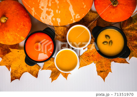 Autumn food. Pumpkin puree soup, leaves. Top view. Autumn harvest, pumpkins, leaves on grey as abstract background. Thanksgiving day. Flat lay. 71351970