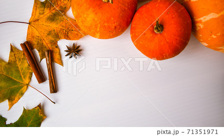 Autumn food. Frame of pumpkin puree soup, leaves. Top view. Autumn harvest, pumpkins, leaves on grey as abstract background. Thanksgiving day. Flat lay. Copy space 71351971