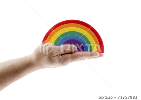 Colorful rainbow in hand isolated on white background with clipping path. LGBTQ+ related symbol. 71357983