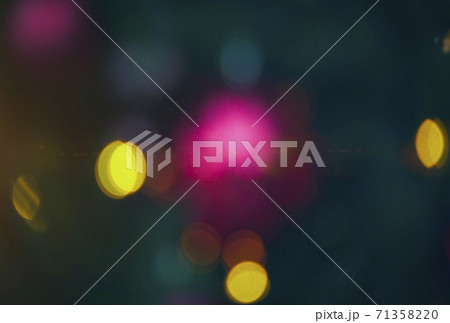 Defocused blurred festive bokeh lights. Blurred garland on Christmas tree as background 71358220