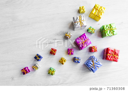 Multicolored bright holiday gift boxes of various sizes on a white background. Copy space 71360308