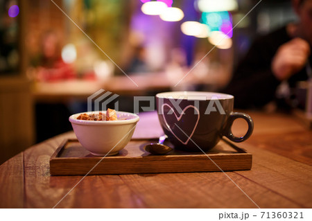 Serving cream soup in a cup with a cup of rusks on a wooden tray Serving cream soup in a cup with a cup of rusks on a wooden tray 71360321