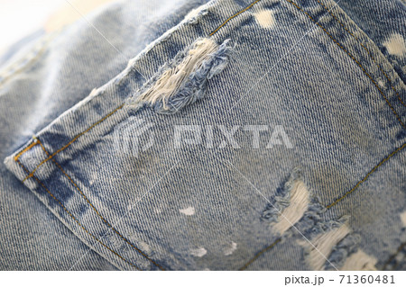Back pocket of jeans with frayed and thread. 71360481
