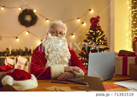 Mature Santa in traditional red costume ready to congratulate online at home Mature Santa in traditional red costume ready to congratulate online at home 71361519